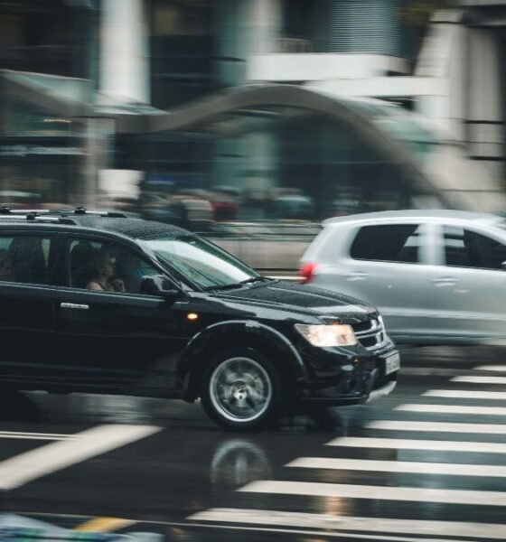 Passenger cars driving through a busy city intersection, illustrating India’s growing road transport and fuel demand