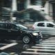 Passenger cars driving through a busy city intersection, illustrating India’s growing road transport and fuel demand