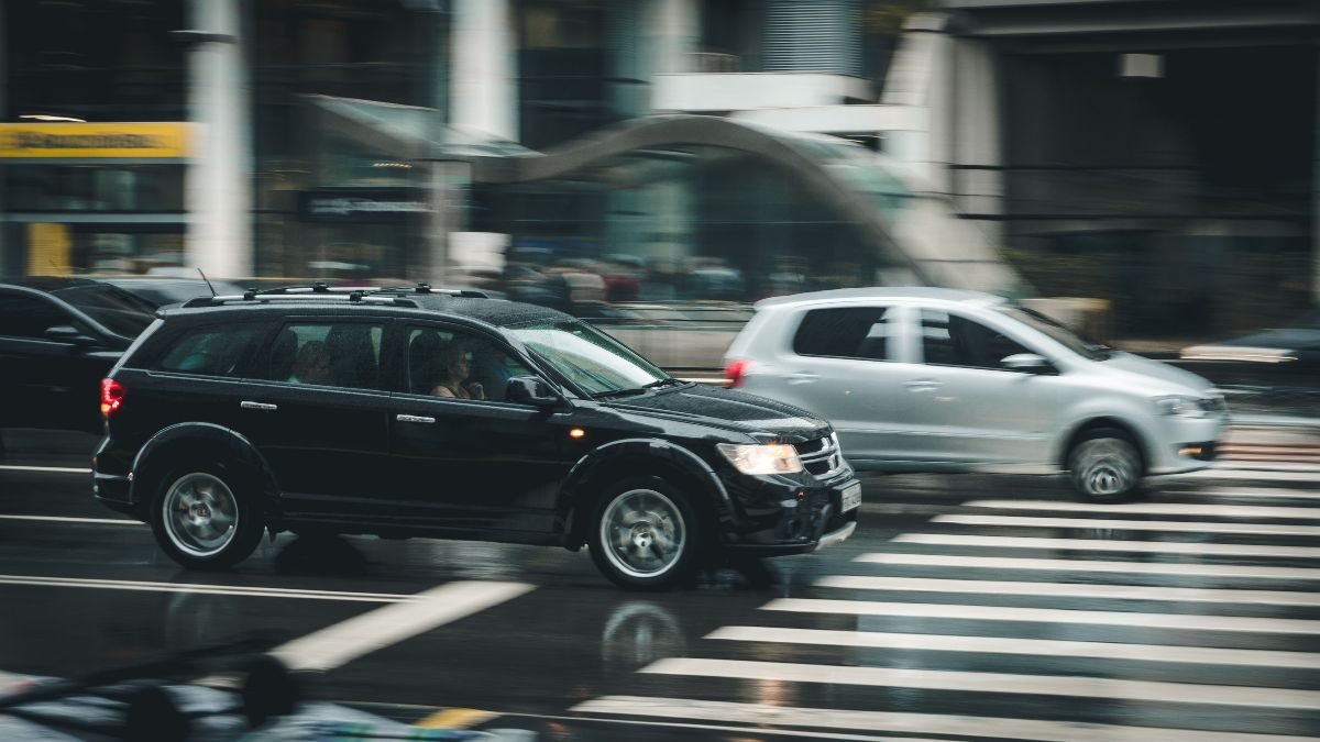 Passenger cars driving through a busy city intersection, illustrating India’s growing road transport and fuel demand