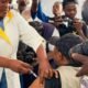 Healthcare worker administers an Ebola vaccine injection to a person as photographers document the vaccination.