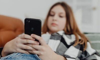 Teenager using a smartphone as Greece moves to ban social media access for children under 15.