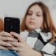 Teenager using a smartphone as Greece moves to ban social media access for children under 15.