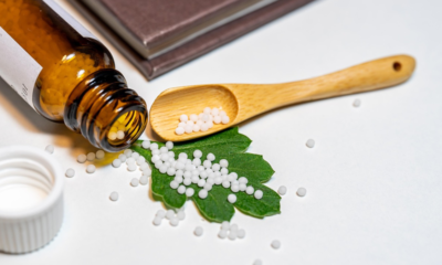 White homoeopathic medicine pellets in an open cloth pouch, illustrating homoeopathic medicine dispensing.