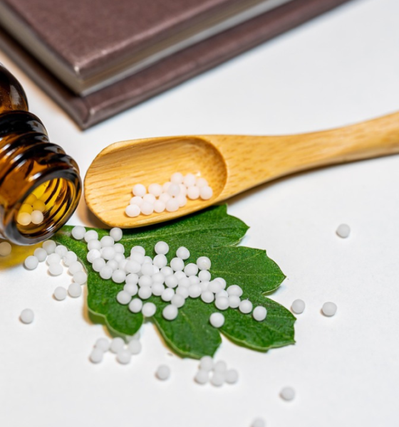 White homoeopathic medicine pellets in an open cloth pouch, illustrating homoeopathic medicine dispensing.