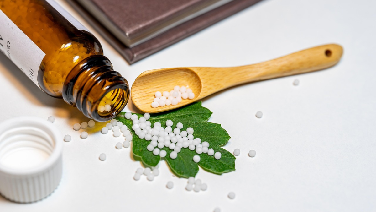 White homoeopathic medicine pellets in an open cloth pouch, illustrating homoeopathic medicine dispensing.