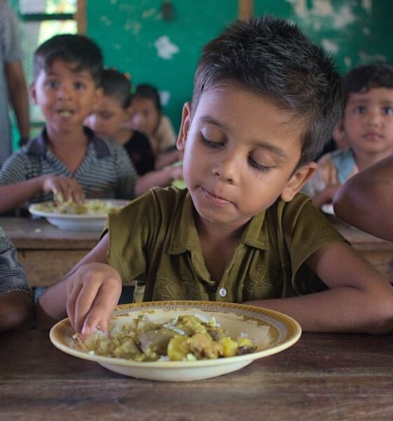 School meal workers prepare food for children in a school feeding programme