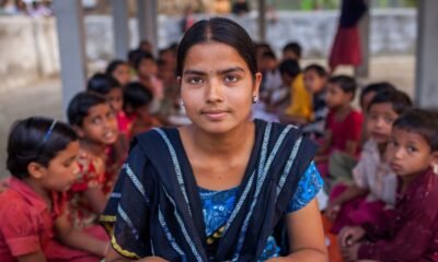 Schoolgirl seated in front of other students in a classroom, illustrating the importance of inclusive education and identifying children who may need additional learning support.