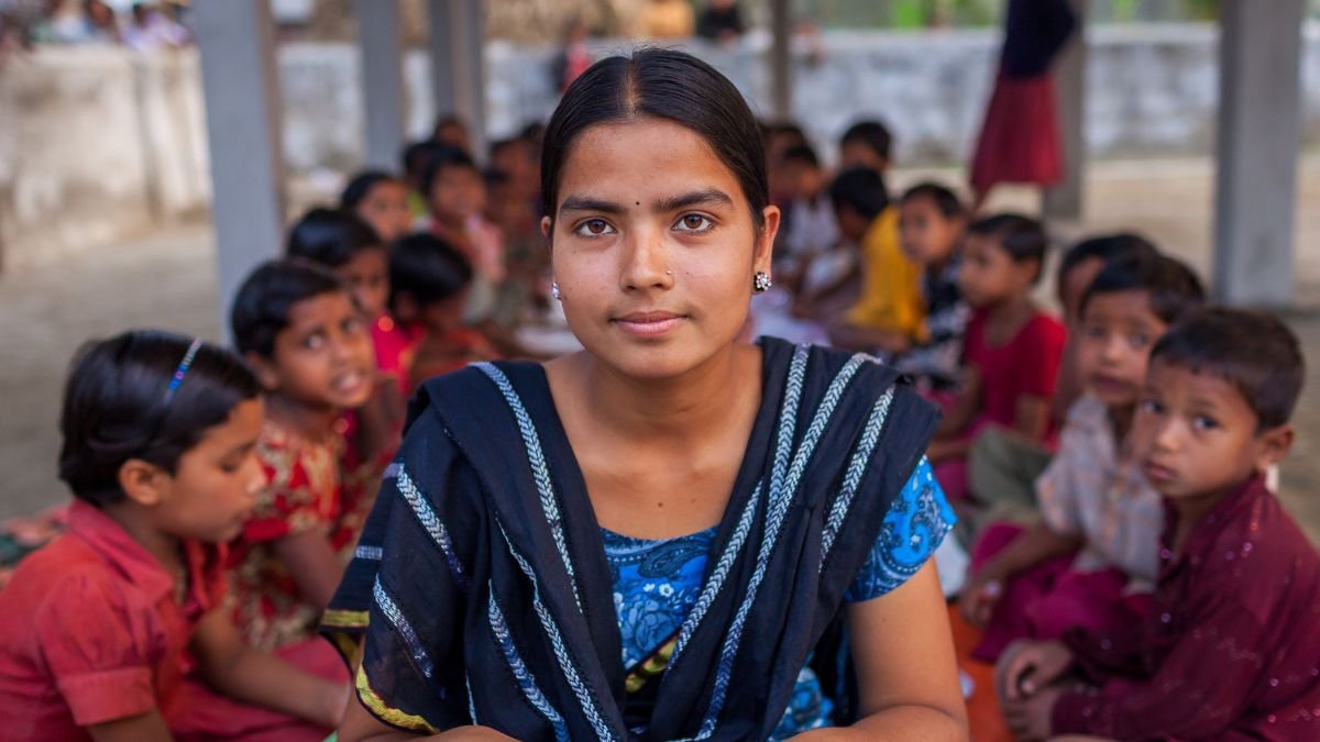 Schoolgirl seated in front of other students in a classroom, illustrating the importance of inclusive education and identifying children who may need additional learning support.