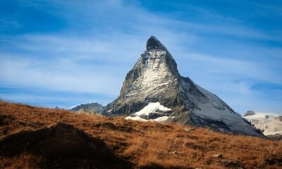 Matterhorn mountain with snow-covered slopes rising above a dry Alpine landscape in Switzerland
