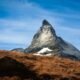 Matterhorn mountain with snow-covered slopes rising above a dry Alpine landscape in Switzerland
