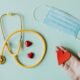 Stethoscope, medical mask and red heart symbolising the links between public health and climate action.