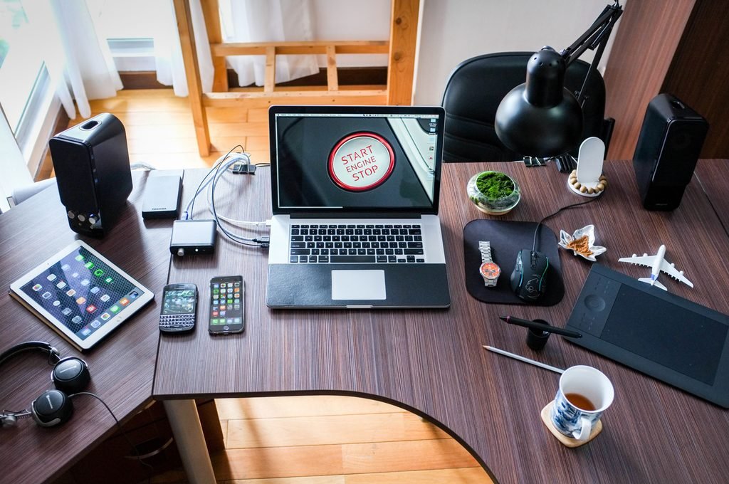 Laptop, smartphones, tablet and other internet-connected electronic devices arranged on a desk, illustrating the growing network of devices potentially exposed to AI-driven cybersecurity threats.